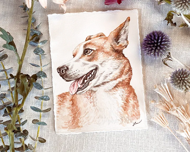 Watercolor portrait of a tan dog in profile