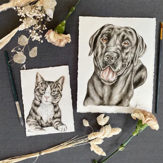Framed watercolor cat and dog portraits styled with dried flowers